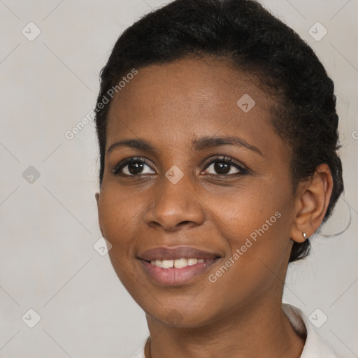 Joyful black young-adult female with short  brown hair and brown eyes