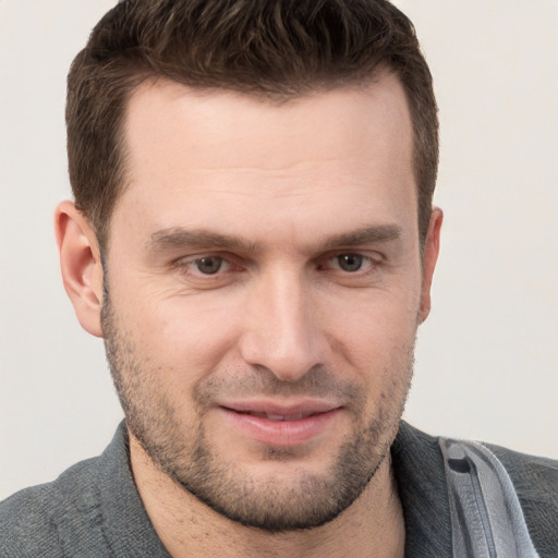 Joyful white adult male with short  brown hair and grey eyes