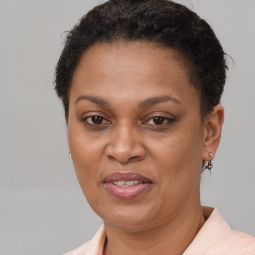 Joyful latino adult female with short  brown hair and brown eyes