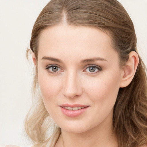 Joyful white young-adult female with long  brown hair and blue eyes