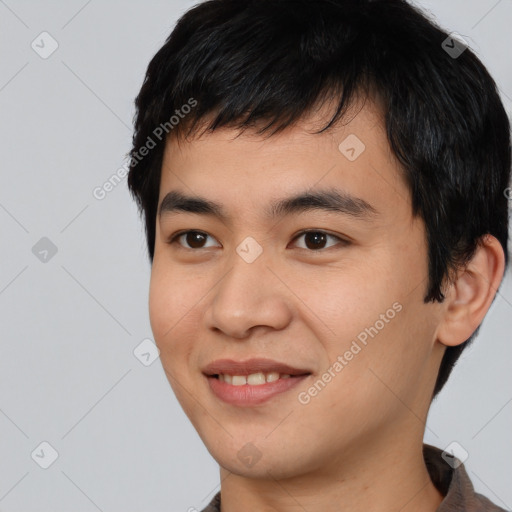 Joyful asian young-adult male with short  black hair and brown eyes