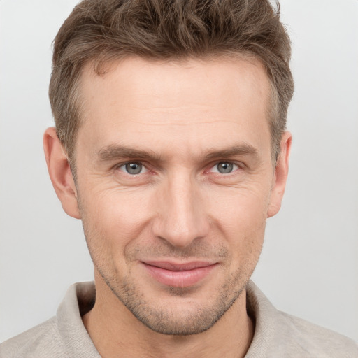 Joyful white adult male with short  brown hair and grey eyes