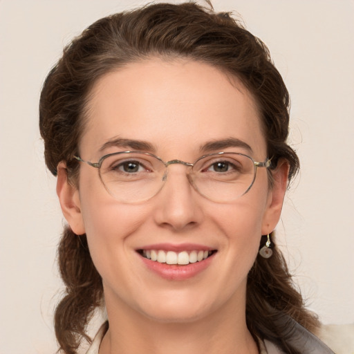 Joyful white adult female with medium  brown hair and grey eyes