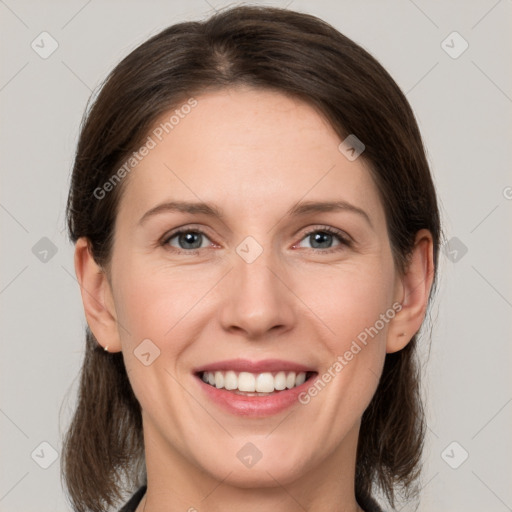 Joyful white adult female with medium  brown hair and grey eyes