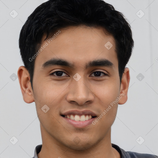 Joyful latino young-adult male with short  black hair and brown eyes