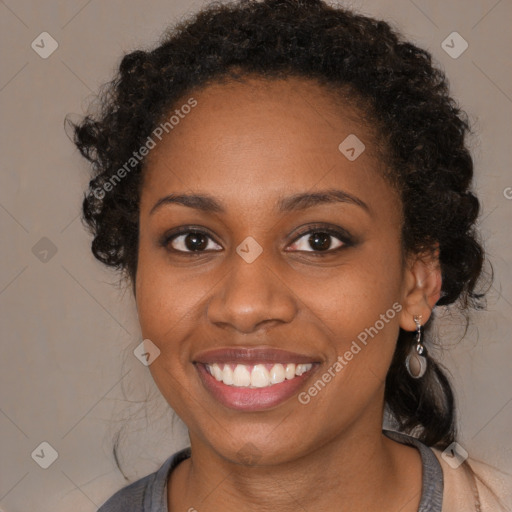 Joyful black young-adult female with long  brown hair and brown eyes