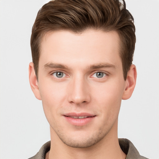 Joyful white young-adult male with short  brown hair and grey eyes