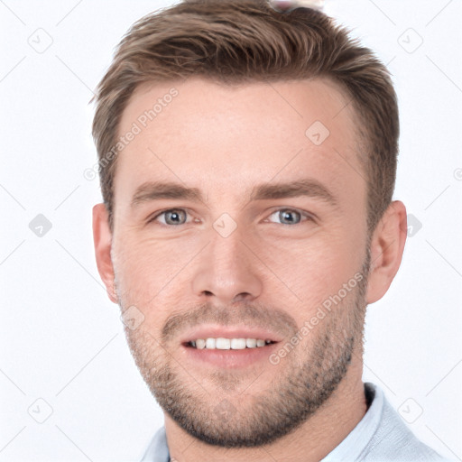 Joyful white young-adult male with short  brown hair and grey eyes