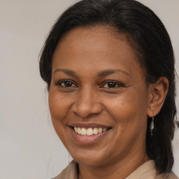 Joyful black adult female with medium  brown hair and brown eyes