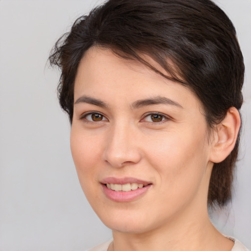 Joyful white young-adult female with medium  brown hair and brown eyes