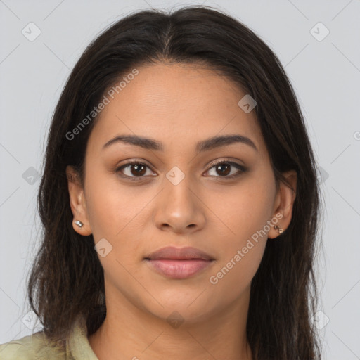 Joyful latino young-adult female with long  brown hair and brown eyes