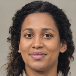 Joyful black adult female with medium  brown hair and brown eyes