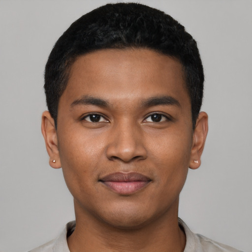 Joyful black young-adult male with short  black hair and brown eyes