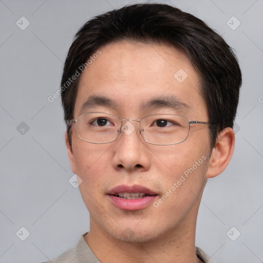 Joyful asian adult male with short  brown hair and brown eyes