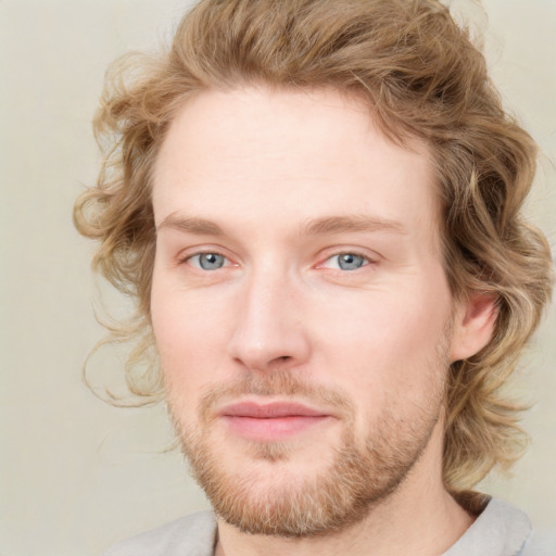 Joyful white young-adult male with short  brown hair and green eyes