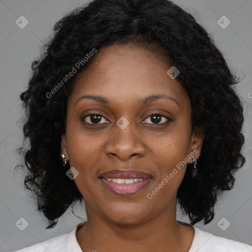 Joyful black young-adult female with long  brown hair and brown eyes