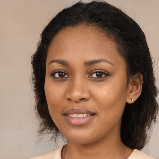 Joyful black young-adult female with medium  brown hair and brown eyes