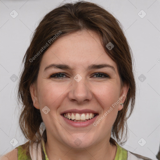 Joyful white young-adult female with medium  brown hair and green eyes