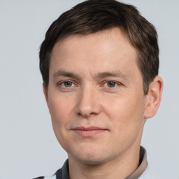 Joyful white adult male with short  brown hair and brown eyes