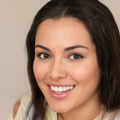 Joyful white young-adult female with long  brown hair and brown eyes