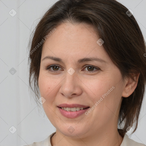 Joyful white adult female with medium  brown hair and brown eyes