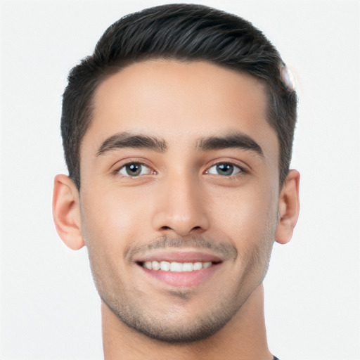 Joyful white young-adult male with short  black hair and brown eyes