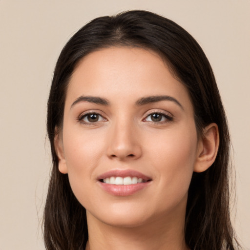 Joyful white young-adult female with long  brown hair and brown eyes