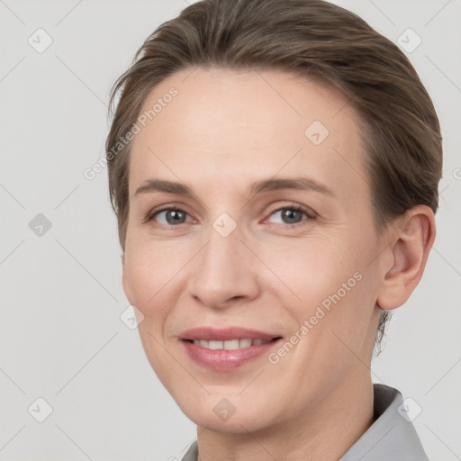 Joyful white young-adult female with short  brown hair and grey eyes