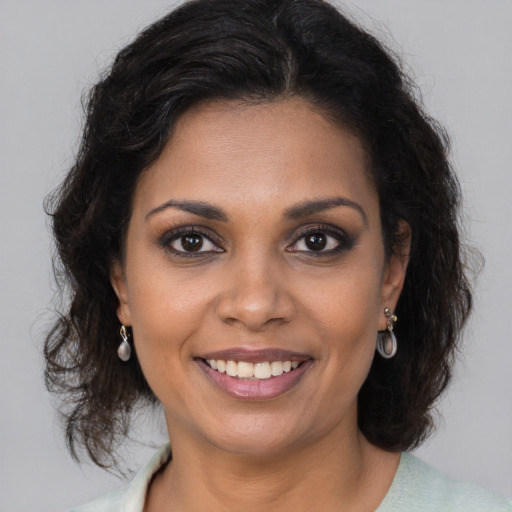 Joyful black young-adult female with medium  brown hair and brown eyes