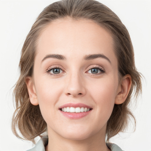 Joyful white young-adult female with medium  brown hair and blue eyes