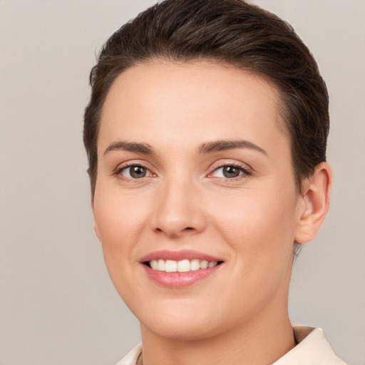 Joyful white young-adult female with short  brown hair and brown eyes