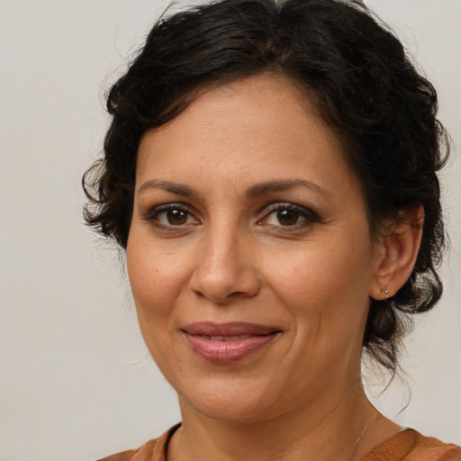 Joyful white adult female with medium  brown hair and brown eyes