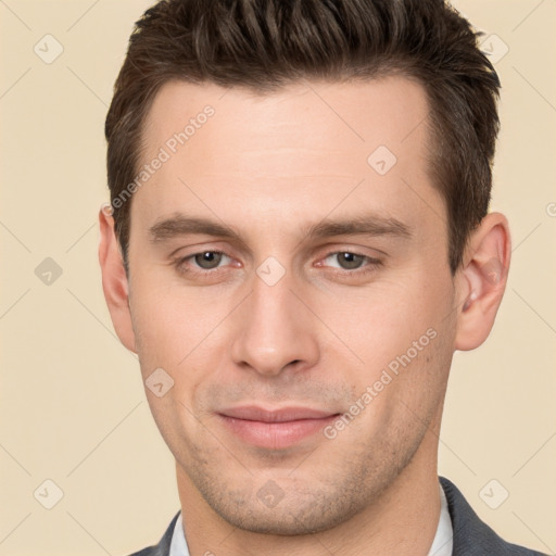 Joyful white young-adult male with short  brown hair and brown eyes