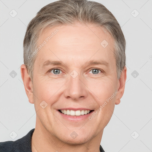 Joyful white adult male with short  brown hair and grey eyes