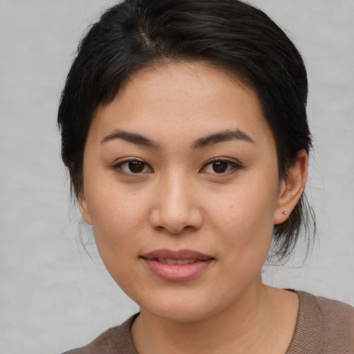 Joyful asian young-adult female with medium  brown hair and brown eyes