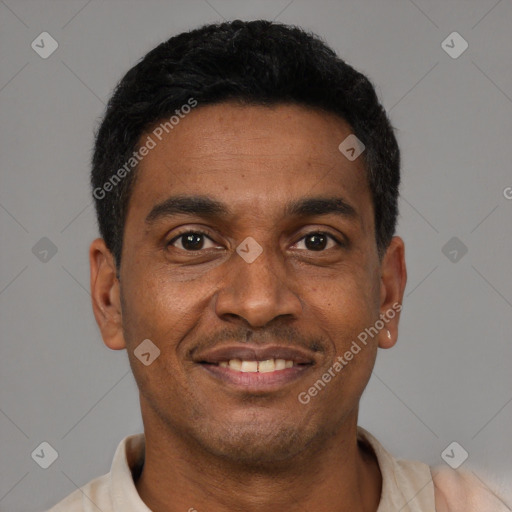 Joyful latino young-adult male with short  black hair and brown eyes