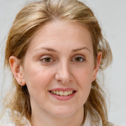 Joyful white young-adult female with medium  brown hair and blue eyes