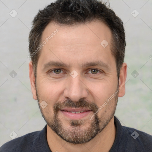 Joyful white adult male with short  brown hair and brown eyes