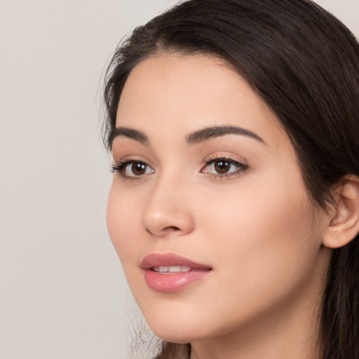 Joyful white young-adult female with long  black hair and brown eyes