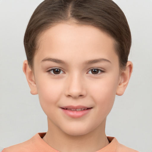 Joyful white child female with short  brown hair and brown eyes