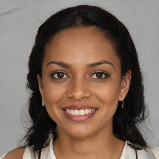 Joyful black young-adult female with medium  brown hair and brown eyes