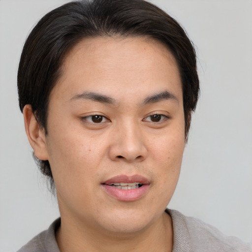 Joyful asian young-adult male with short  brown hair and brown eyes