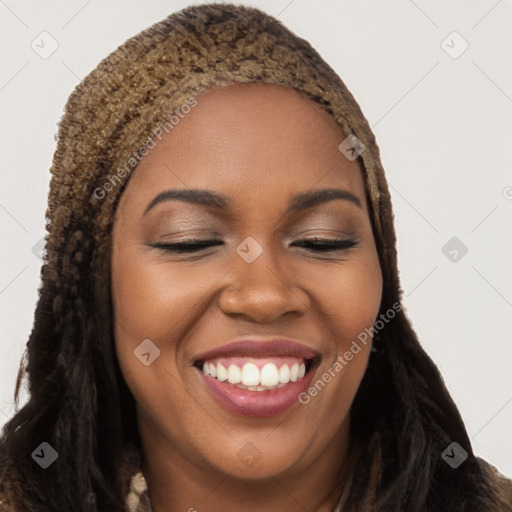 Joyful black young-adult female with long  brown hair and brown eyes