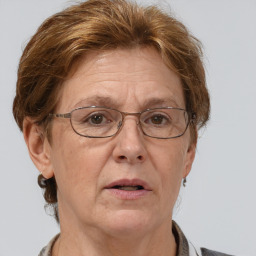 Neutral white middle-aged female with medium  brown hair and grey eyes