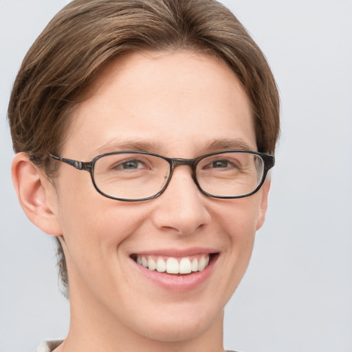 Joyful white young-adult female with short  brown hair and grey eyes