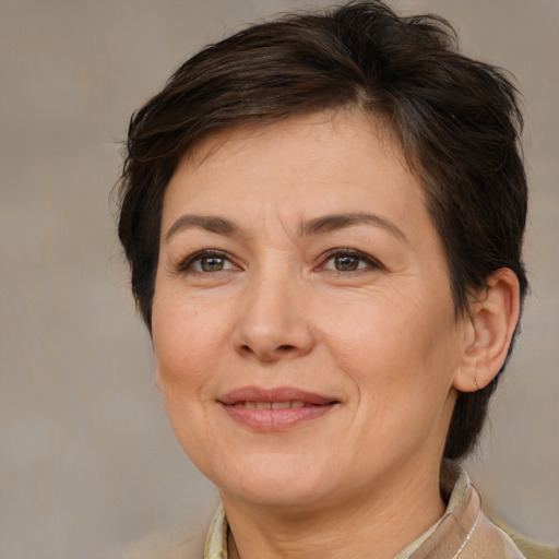 Joyful white adult female with medium  brown hair and brown eyes