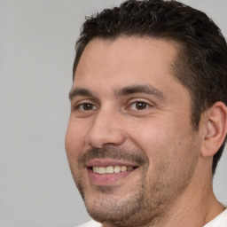 Joyful white adult male with short  brown hair and brown eyes