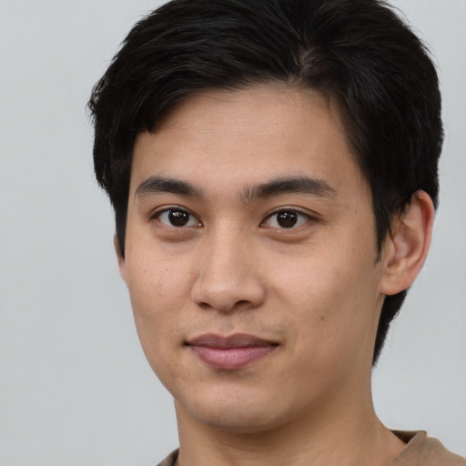 Joyful asian young-adult male with short  brown hair and brown eyes