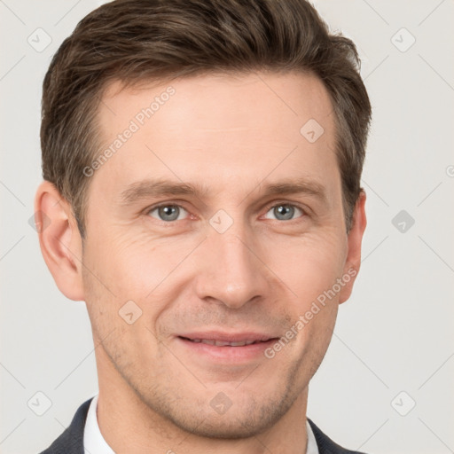 Joyful white young-adult male with short  brown hair and grey eyes