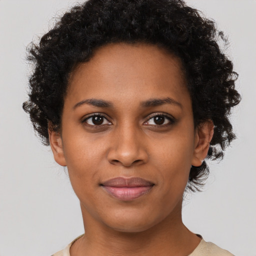 Joyful black young-adult female with short  brown hair and brown eyes
